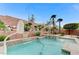 Backyard view of the pool, spa, basketball hoop, and retaining wall with landscaping at 733 Secret London Ave, Las Vegas, NV 89178