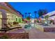 A spacious backyard with a pool, lounge chairs, and a covered patio, ideal for outdoor living at 733 Secret London Ave, Las Vegas, NV 89178