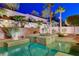 Inviting pool and spa surrounded by lush landscaping and a retaining wall offering a serene outdoor experience at 733 Secret London Ave, Las Vegas, NV 89178