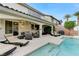 Inviting backyard featuring a covered patio with lounge seating and a sparkling pool with spa at 733 Secret London Ave, Las Vegas, NV 89178