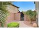 Private gated side yard with a stone pathway and desert landscaping at 733 Secret London Ave, Las Vegas, NV 89178