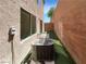 Backyard area with artificial turf, a privacy wall, and an air conditioning unit at 7873 Running Doe Ct, Las Vegas, NV 89149