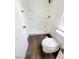 Clean bathroom featuring a tiled shower stall, modern toilet, and wood-look floors, perfect for a refreshing experience at 7873 Running Doe Ct, Las Vegas, NV 89149