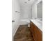 Bathroom features a vanity with solid surface countertop and wood-look flooring at 7873 Running Doe Ct, Las Vegas, NV 89149