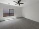 Bright, empty bedroom featuring carpet floors and a large window at 7873 Running Doe Ct, Las Vegas, NV 89149