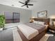 Modern bedroom with a platform bed, large window, and neutral decor at 7873 Running Doe Ct, Las Vegas, NV 89149