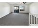 Bright bonus room features carpeted floors, ceiling fan, and large sliding glass door to a balcony at 7873 Running Doe Ct, Las Vegas, NV 89149