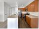 Well-lit kitchen with stainless steel appliances, wooden cabinets, and a peninsula counter at 7873 Running Doe Ct, Las Vegas, NV 89149