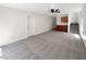 Spacious, carpeted living room with built-in storage and stairs leading upstairs at 7873 Running Doe Ct, Las Vegas, NV 89149