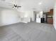 Open concept living area featuring high ceilings, a kitchen island, and modern finishes at 7873 Running Doe Ct, Las Vegas, NV 89149