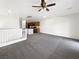 Bright living room featuring neutral walls, plush gray carpeting, and an open floor plan to kitchen at 7873 Running Doe Ct, Las Vegas, NV 89149