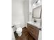 Stylish powder room featuring wood-look floors, updated vanity, modern mirror, and a contemporary toilet at 7873 Running Doe Ct, Las Vegas, NV 89149