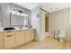 Bright bathroom featuring a wood vanity with black hardware, wood floors, and a toilet at 8000 Badura Ave # 1007, Las Vegas, NV 89113