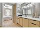 Bathroom featuring a wood vanity with black hardware, view from bedroom with natural light at 8000 Badura Ave # 1007, Las Vegas, NV 89113