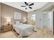 Comfortable bedroom with a ceiling fan, neutral color palette and a view to the bathroom at 8000 Badura Ave # 1007, Las Vegas, NV 89113