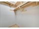 Empty walk-in closet features custom wood shelving at 8000 Badura Ave # 1007, Las Vegas, NV 89113