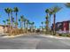Welcoming community entrance with palm trees and well-maintained brick-paved road at 8000 Badura Ave # 1007, Las Vegas, NV 89113