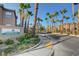 The community street sign framed by lush landscaping and many palm trees at 8000 Badura Ave # 1007, Las Vegas, NV 89113