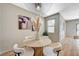 Light and airy dining room features round table and modern chairs, neutral color palette at 8000 Badura Ave # 1007, Las Vegas, NV 89113