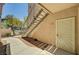Apartment entrance with a unique security door, convenient access via stairs, and desert-friendly landscaping at 8000 Badura Ave # 1007, Las Vegas, NV 89113