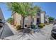 Charming multi-Gathering building showcasing well-maintained landscaping and a tree providing shade on a sunny day at 8000 Badura Ave # 1007, Las Vegas, NV 89113