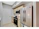 Well-equipped kitchen with stainless steel refrigerator and light wood cabinetry at 8000 Badura Ave # 1007, Las Vegas, NV 89113