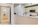 Convenient kitchen pass-through to living area with white countertops at 8000 Badura Ave # 1007, Las Vegas, NV 89113
