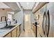 Open kitchen layout with stainless steel appliances and access to laundry at 8000 Badura Ave # 1007, Las Vegas, NV 89113