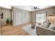 Comfortable living room featuring wood floors, a ceiling fan, and a sliding glass door to the patio at 8000 Badura Ave # 1007, Las Vegas, NV 89113