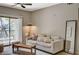 Bright living room with a large sliding door to a balcony, comfortable sofa, and modern decor at 8000 Badura Ave # 1007, Las Vegas, NV 89113