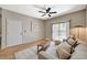 Stylish living room featuring a ceiling fan, sliding glass doors, and light wood flooring at 8000 Badura Ave # 1007, Las Vegas, NV 89113