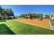 Community playground with green lawn and mature trees, ideal for ' outdoor activities at 8000 Badura Ave # 1007, Las Vegas, NV 89113
