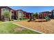 Community playground with green lawn and mature trees, a fun space for ' outdoor enjoyment at 8000 Badura Ave # 1007, Las Vegas, NV 89113