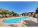Community pool surrounded by lush landscaping and seating, perfect for relaxing and enjoying the outdoors at 8000 Badura Ave # 1007, Las Vegas, NV 89113