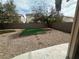 Low maintenance backyard with gravel landscaping and green turf at 8215 Shell Beach Ct, Las Vegas, NV 89117