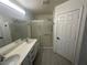 Bathroom features a double sink vanity with shower behind sliding glass doors at 8215 Shell Beach Ct, Las Vegas, NV 89117