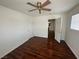 Bedroom with ceiling fan, hardwood floors, a large window and neutral walls at 8215 Shell Beach Ct, Las Vegas, NV 89117