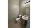 Cozy half bathroom with pedestal sink and a neutral color palette at 8215 Shell Beach Ct, Las Vegas, NV 89117