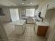 Modern kitchen featuring white cabinetry, quartz countertops, and an island at 8215 Shell Beach Ct, Las Vegas, NV 89117