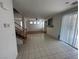 Open living space with hardwood and tile flooring, and a staircase leading to the upper level at 8215 Shell Beach Ct, Las Vegas, NV 89117