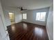 Bright main bedroom with hardwood flooring, ceiling fan, and ensuite bath at 8215 Shell Beach Ct, Las Vegas, NV 89117