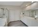This bathroom offers a double sink vanity, walk-in shower, and white cabinets at 8333 Valley Stream Ave, Las Vegas, NV 89131