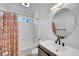 Stylish bathroom showcasing a modern sink and a shower with a colorful curtain at 8333 Valley Stream Ave, Las Vegas, NV 89131