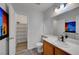 Bright bathroom featuring a single sink vanity and shelved closet for ample storage at 8333 Valley Stream Ave, Las Vegas, NV 89131