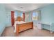 Cozy bedroom with blue walls, carpeted floors, a desk, and natural light at 8333 Valley Stream Ave, Las Vegas, NV 89131
