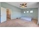 Spacious bedroom features a ceiling fan, carpeted floors, and serene blue walls at 8333 Valley Stream Ave, Las Vegas, NV 89131
