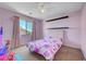Charming lilac bedroom featuring a window view and playful decor at 8333 Valley Stream Ave, Las Vegas, NV 89131