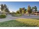 Well-maintained neighborhood park featuring a walking path, mature trees, and lush landscaping at 8333 Valley Stream Ave, Las Vegas, NV 89131