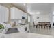 Modern kitchen with white cabinets and appliances, connected to a dining area with a wood table at 8333 Valley Stream Ave, Las Vegas, NV 89131