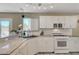 Well-lit kitchen featuring granite countertops, stainless steel appliances, and white cabinetry at 8333 Valley Stream Ave, Las Vegas, NV 89131